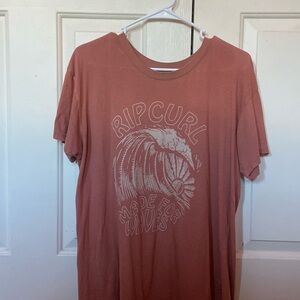 A pink flowy billabong T shirt